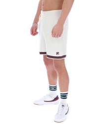 Person wearing white shorts with red and blue stripes on a white background