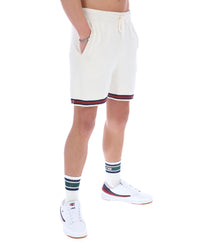Person wearing white shorts with red and blue trim on a white background