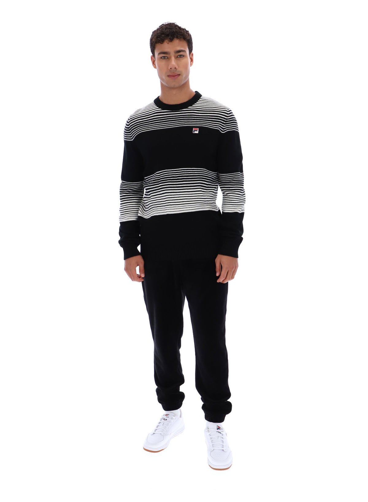 Displays a model wearing the Black 'FILA' branded Connor Striped Knit Crew Neck