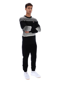 Displays a model wearing the Black 'FILA' branded Connor Striped Knit Crew Neck