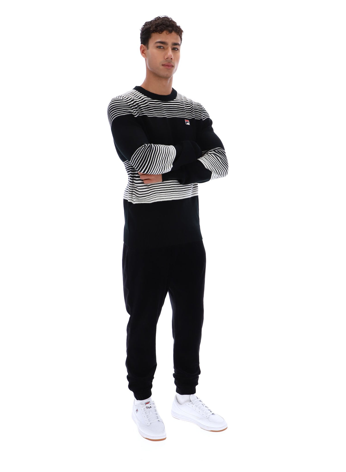 Displays a model wearing the Black 'FILA' branded Connor Striped Knit Crew Neck