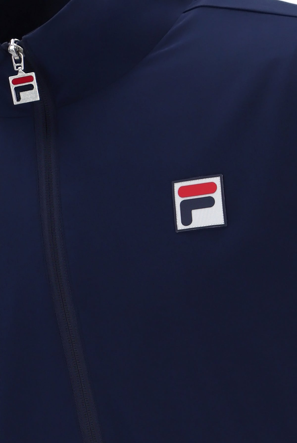 A navy blue tennis track top with zip up fastening, featuring the British flag and the FILA logo on the chest.