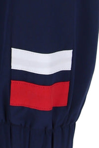 A navy blue tennis track top with zip up fastening, featuring the white and red detailing on the sleeve