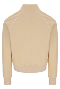 Beige jacket with white piping on a white background