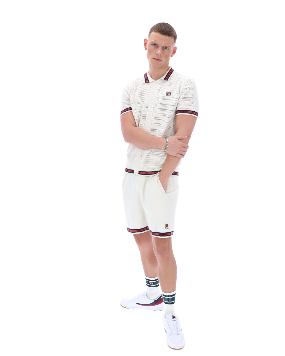Person wearing a white tennis outfit with maroon accents on a white background