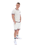 Man wearing a white outfit with red accents on a white background