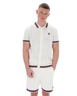 Man wearing a white patterned shirt and shorts with red and navy accents on a white background