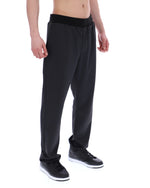 Person wearing black patterned pants on a white background