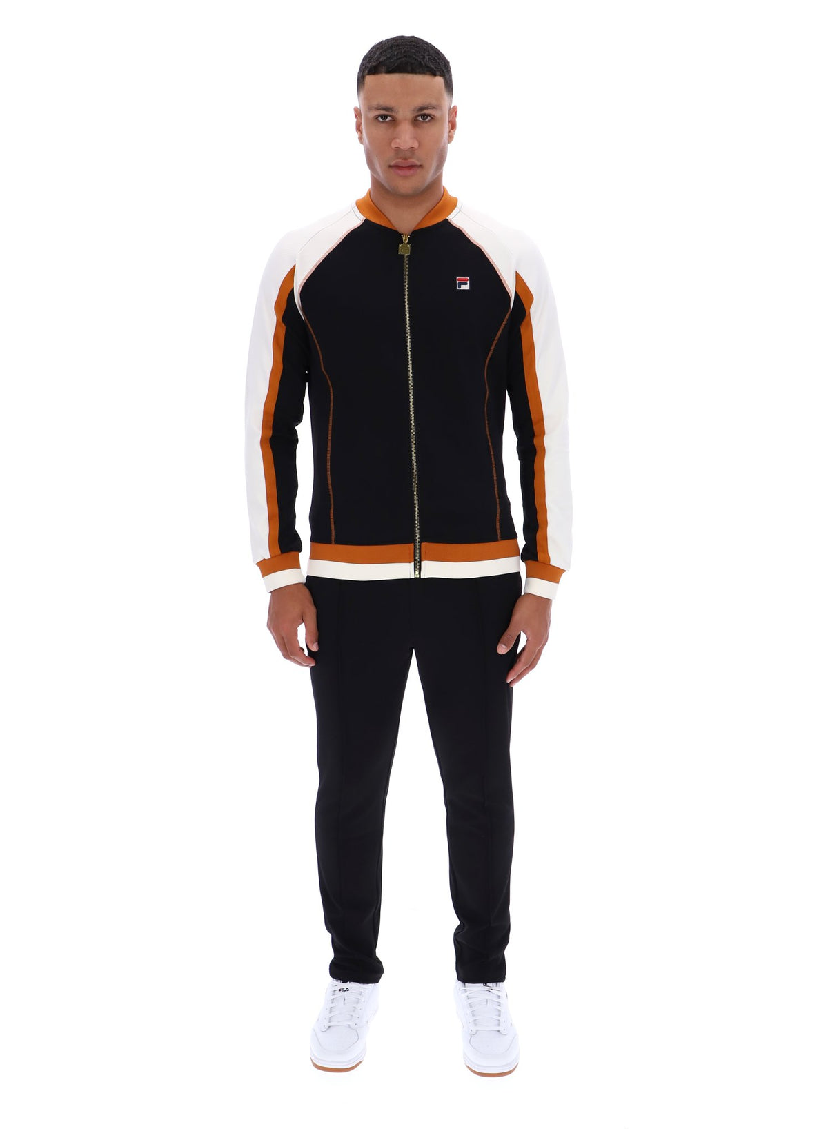 Man wearing a black and orange tracksuit with a FILA logo on a white background