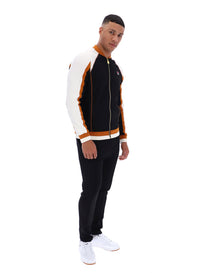 Man wearing a black and white tracksuit with orange accents on a white background