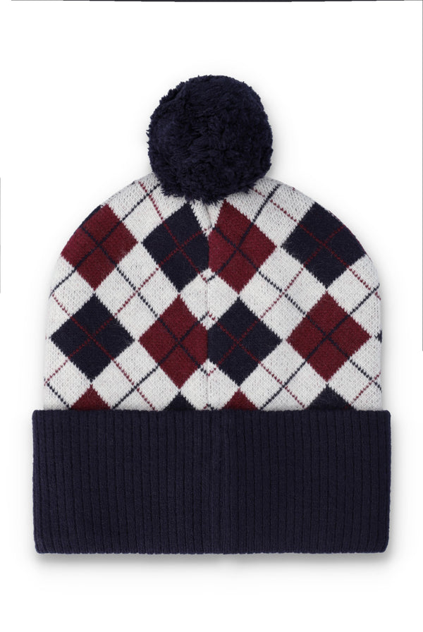 A knit pom-pom beanie hat featuring an argyle pattern in white, navy, and burgundy, with a solid navy ribbed cuff and pom-pom.