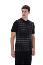 A man wearing a black short-sleeve polo shirt with a white windowpane plaid pattern on the front panel and a small gold embroidered logo on the chest, photographed against a plain white background.