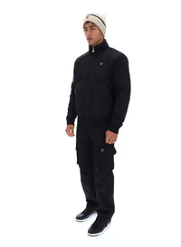 Displays a model wearing the Black 'FILA' branded Etton Bomber Jacket