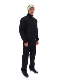 Displays a model wearing the Black 'FILA' branded Etton Bomber Jacket