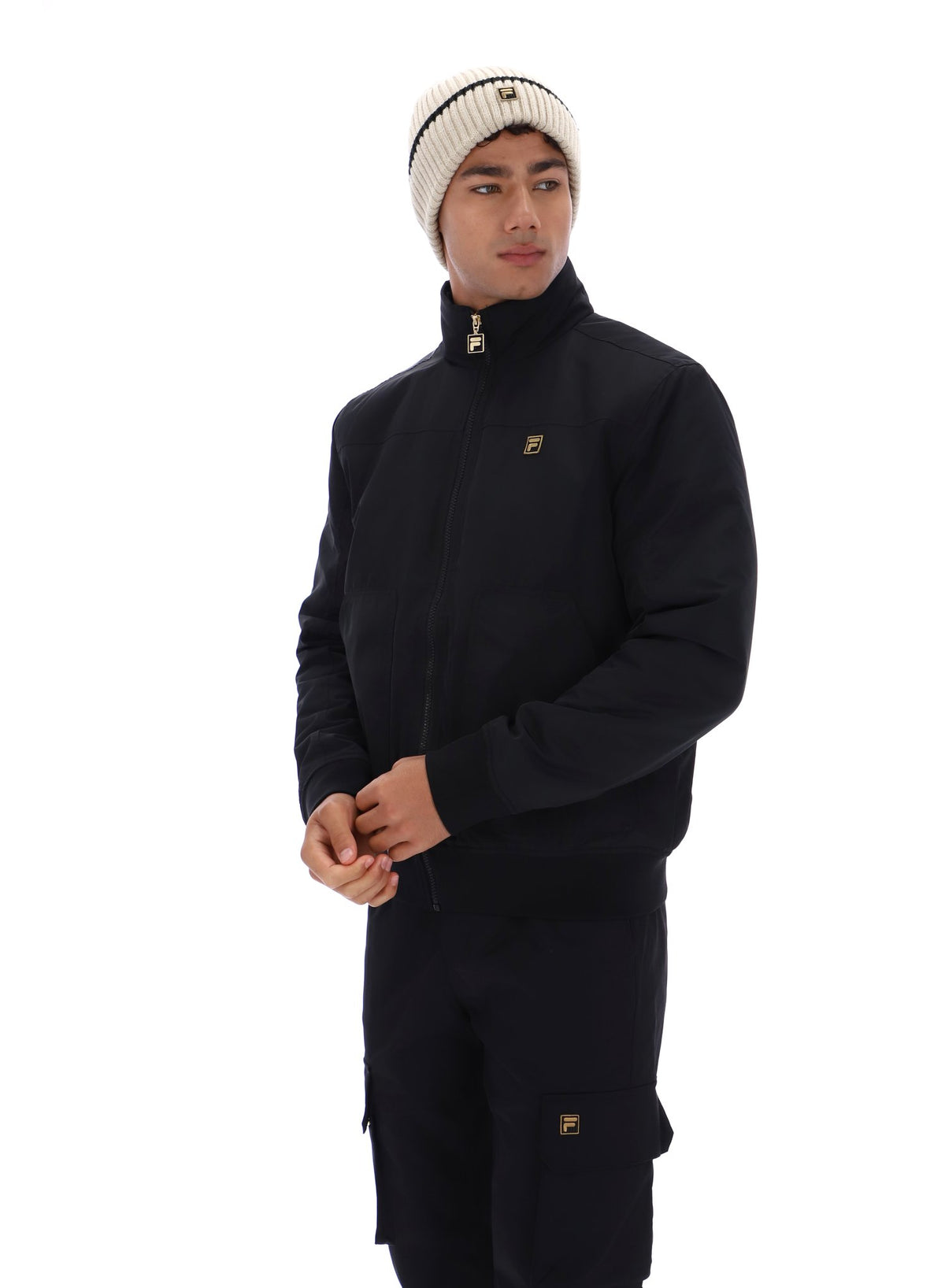 Displays a model wearing the Black 'FILA' branded Etton Bomber Jacket