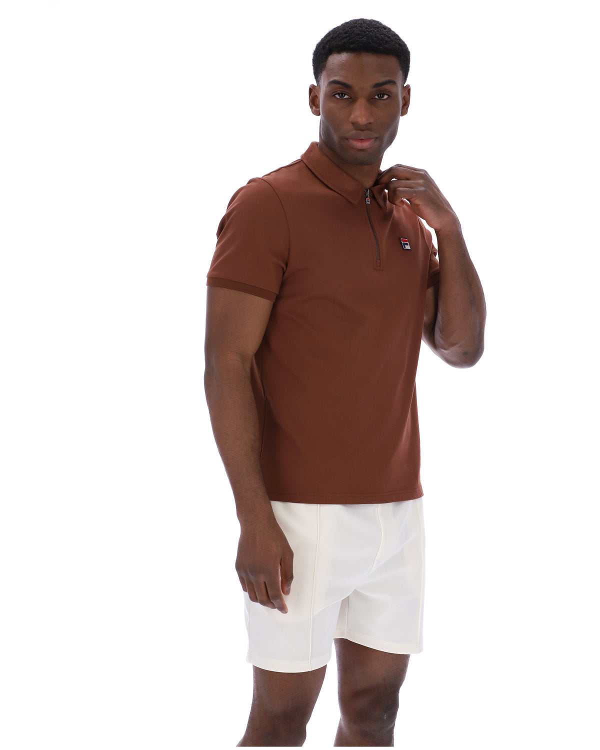 Man wearing a brown polo shirt and white shorts on a white background