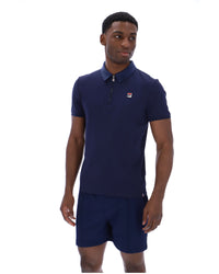 Displays a model wearing the Navy 'Fila' branded Ettore Zip Polo
