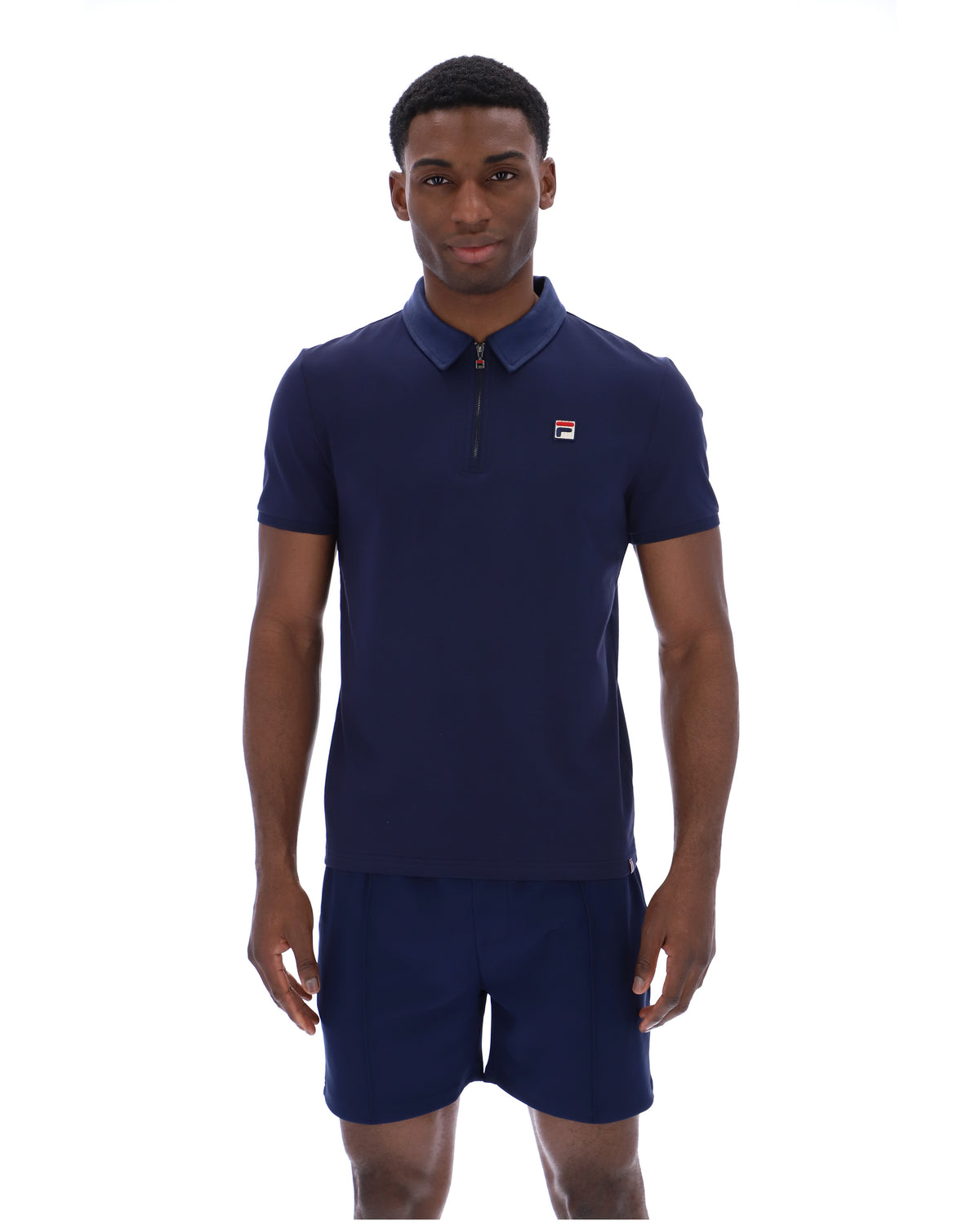 Displays a model wearing the Navy 'Fila' branded Ettore Zip Polo