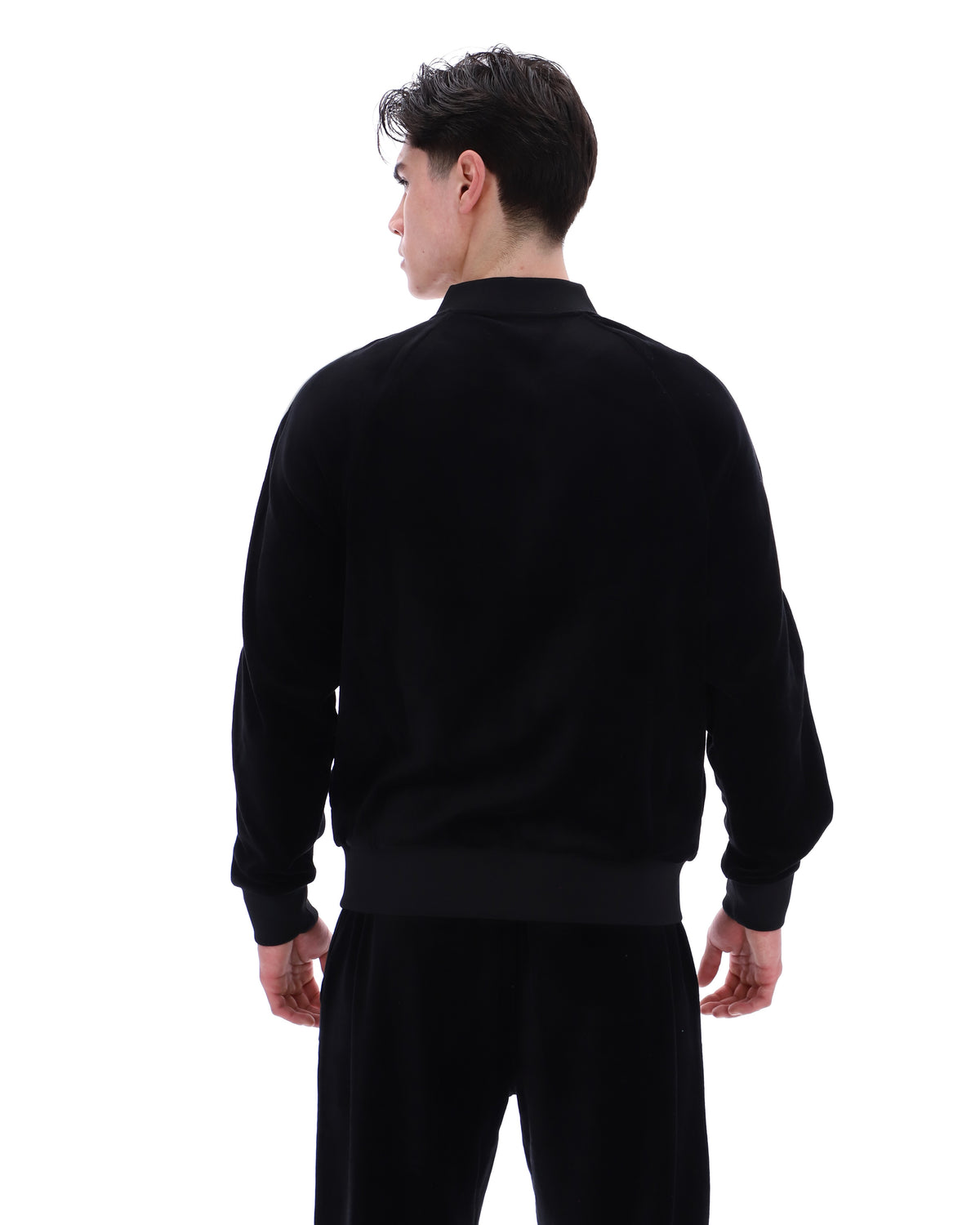 Displays a model wearing the Black 'FILA' Fella Velour Jacket