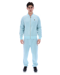Man wearing a light blue tracksuit on a white background