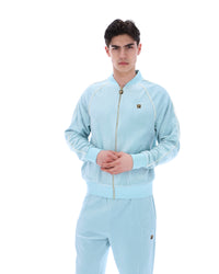 Man wearing a light blue tracksuit on a white background