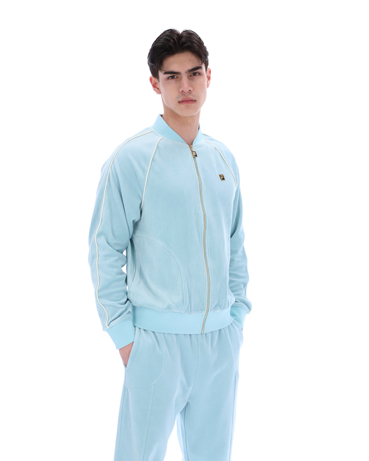 Person wearing a light blue tracksuit on a white background