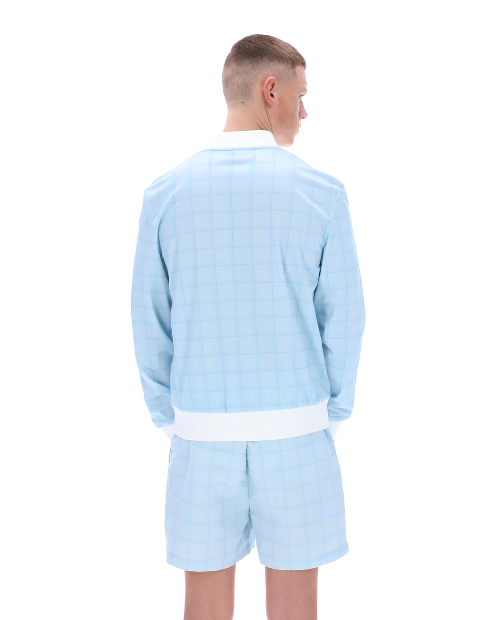 Person wearing a light blue pajama set on a white background