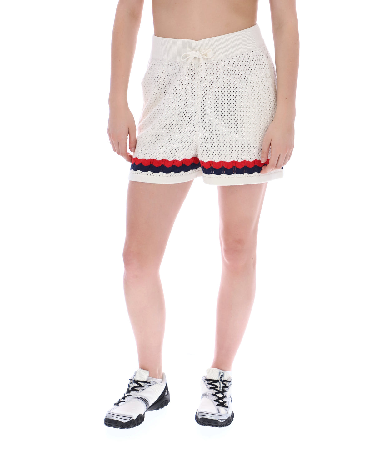 Displays a model wearing the Fino 'FILA' branded Knitted Crochet Shorts