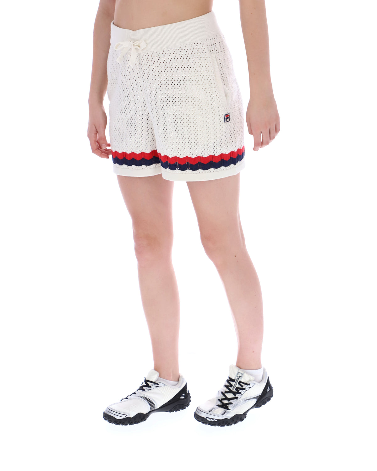Displays a model wearing the Fino 'FILA' branded Knitted Crochet Shorts