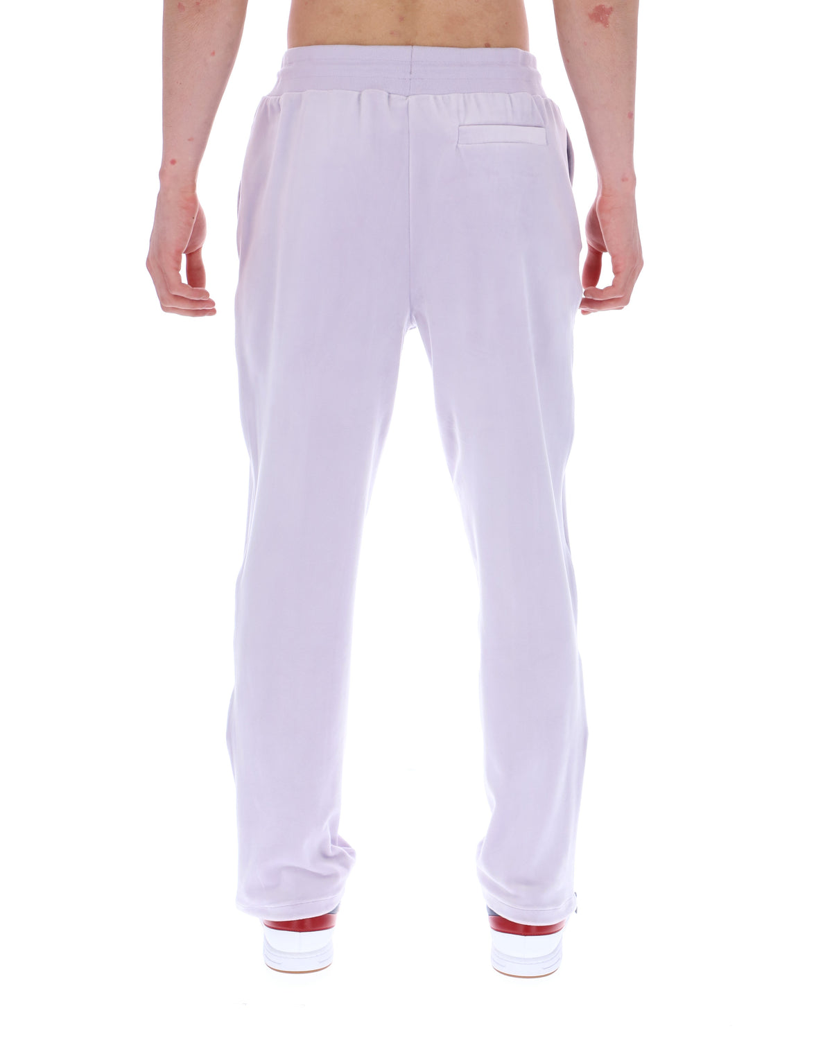 Displays the model wearing the Misty Lilac 'FILA' branded Fio Velour Straight-Leg Jogger