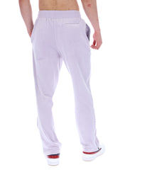 Displays the model wearing the Misty Lilac 'FILA' branded Fio Velour Straight-Leg Jogger