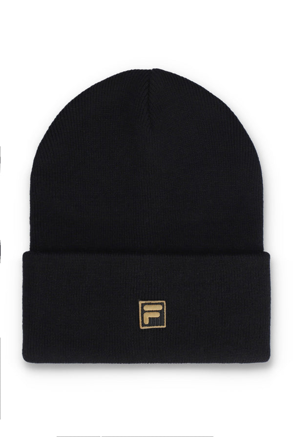 A black knit beanie hat with a folded cuff and a small gold-tone Fila logo patch on the front, shown against a plain white background.