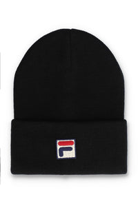 A black knit beanie hat featuring a small embroidered Fila logo patch on the front of the folded cuff, set against a plain white background.