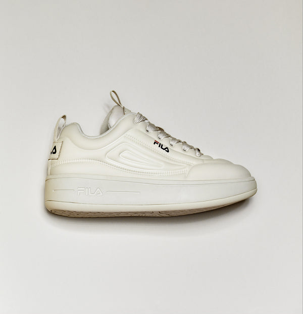 A pair of beige FILA Superbubble Trainers with lace-up closure and the FILA logo visible on the side.