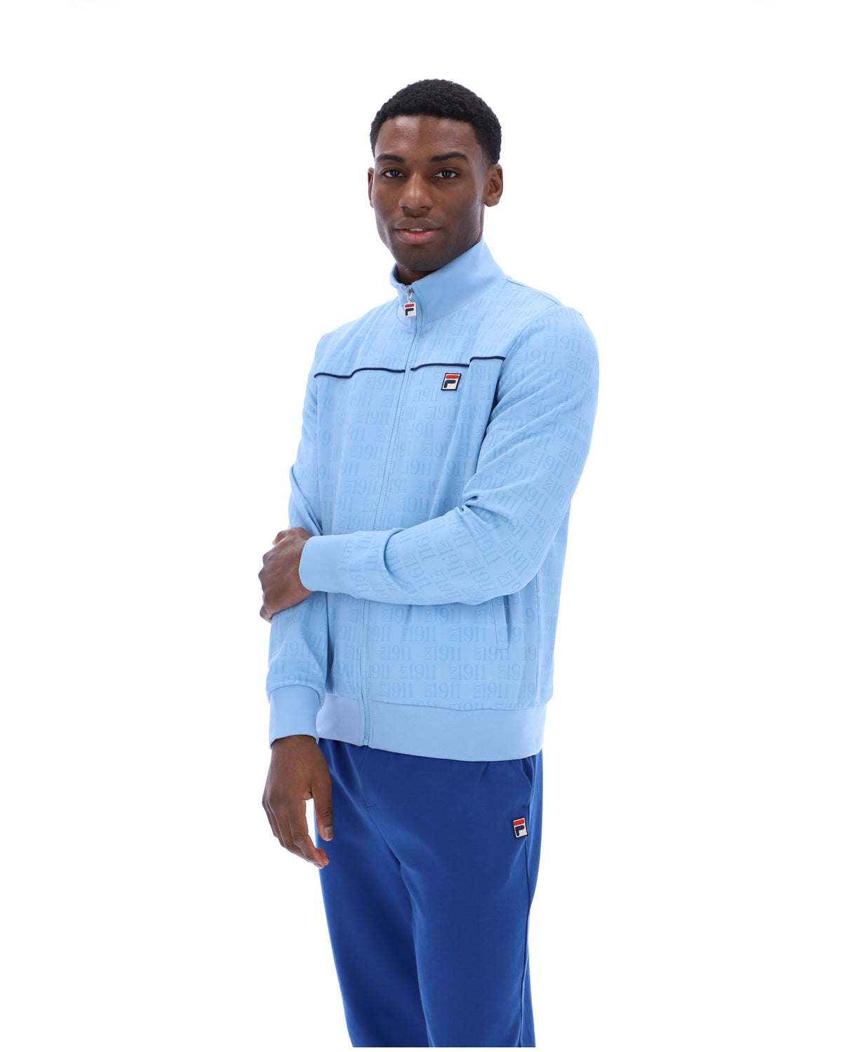 Man wearing a light blue jacket and blue pants on a white background