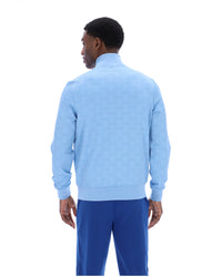 Man wearing a light blue sweater and blue pants on a white background
