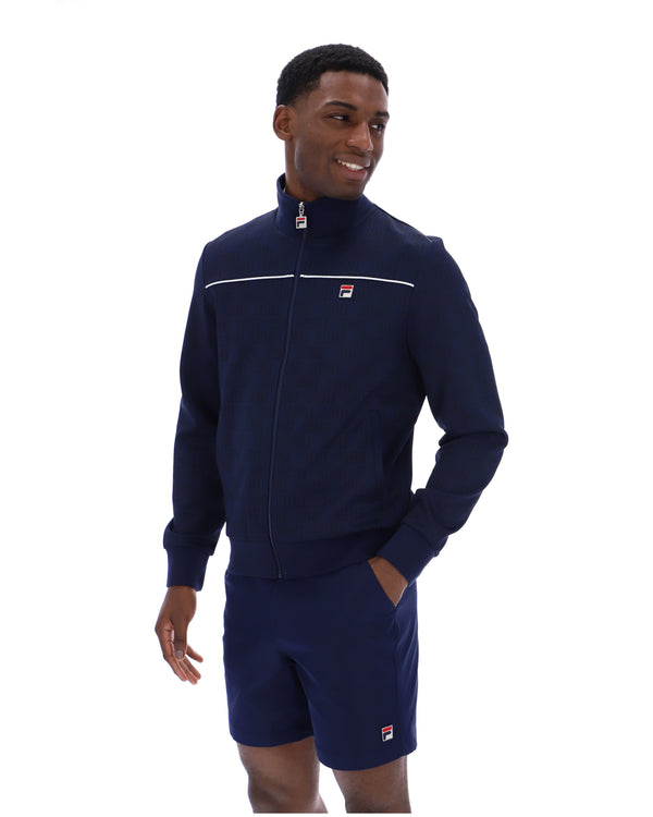 Man wearing a navy tracksuit with a brand logo on a white background