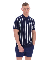 Man wearing a navy and white striped shirt with a logo on a white background