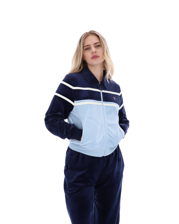 Woman wearing a blue and white tracksuit on a white background