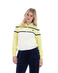 Woman wearing a yellow and white jacket with navy pants on a white background