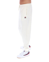 White sweatpants with a FILA logo worn by a person on a white background