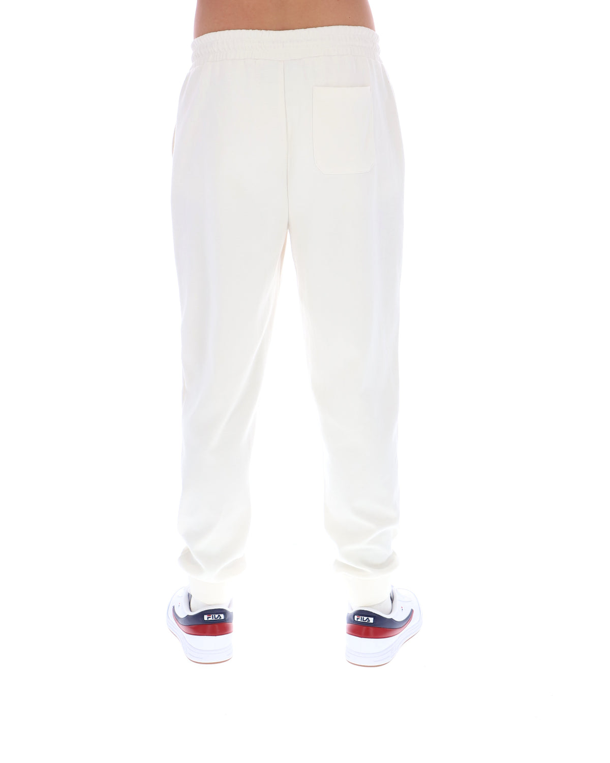 White sweatpants worn by a person on a white background