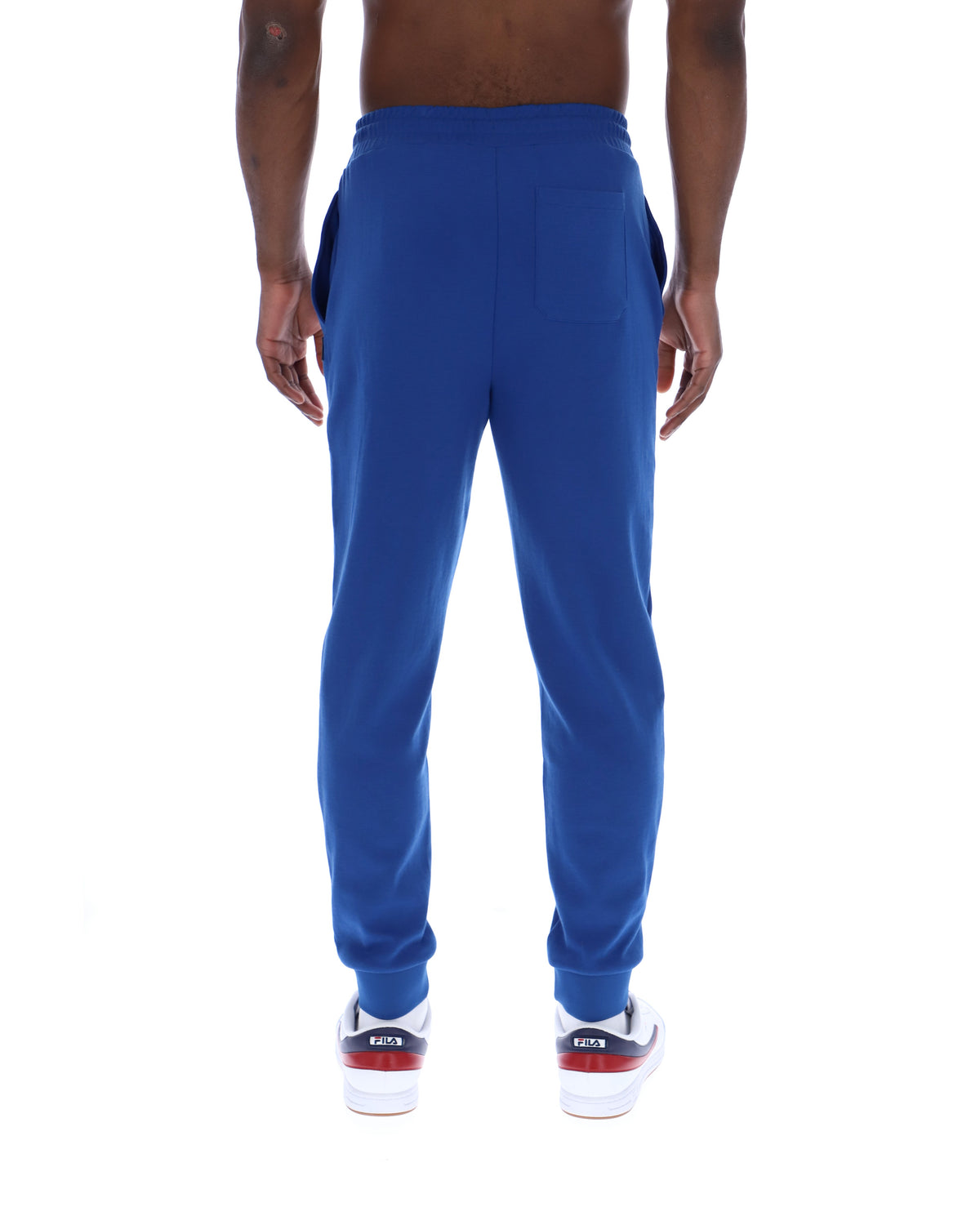 Blue sweatpants worn by a person on a white background