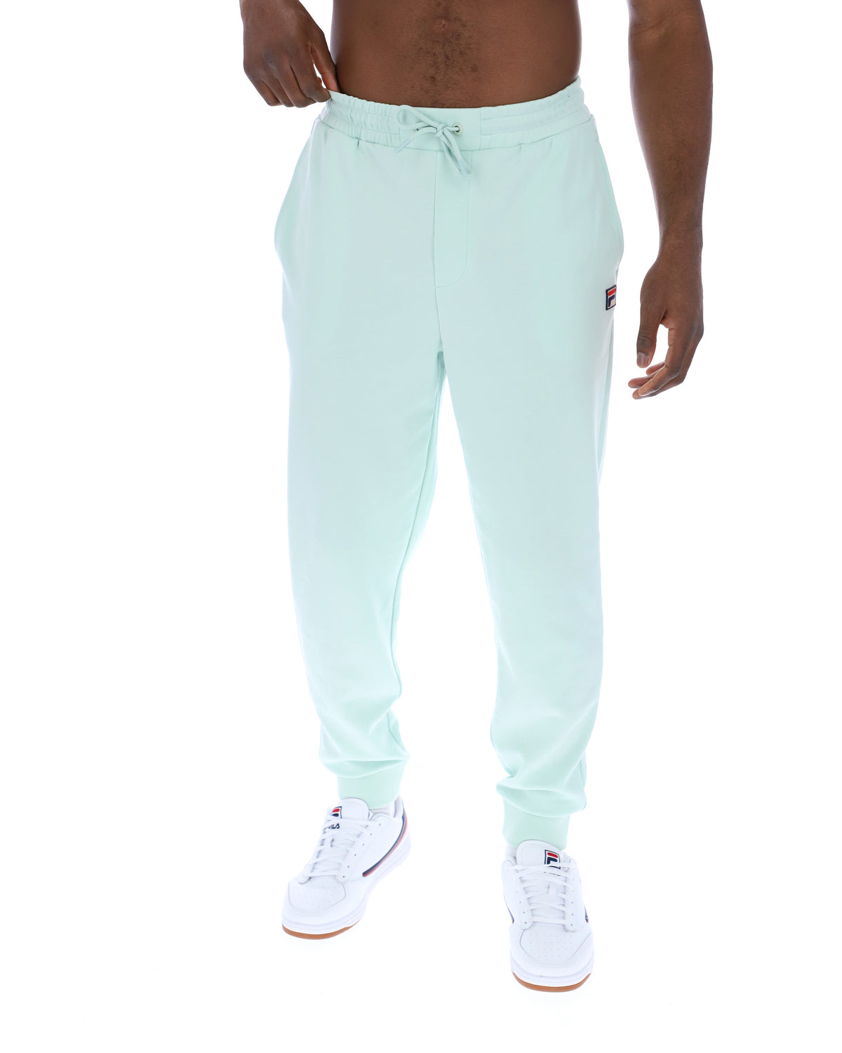 Light blue jogger pants worn by a person on a white background