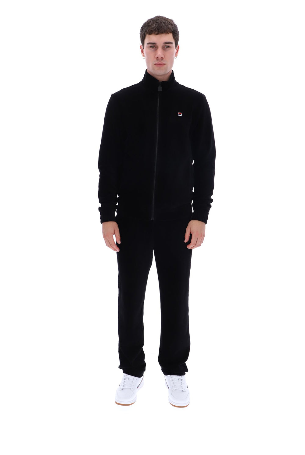 A man modeling a black fleece zip-up jacket and matching black pants, featuring a small red and white Filson logo on the left chest, against a plain white background.