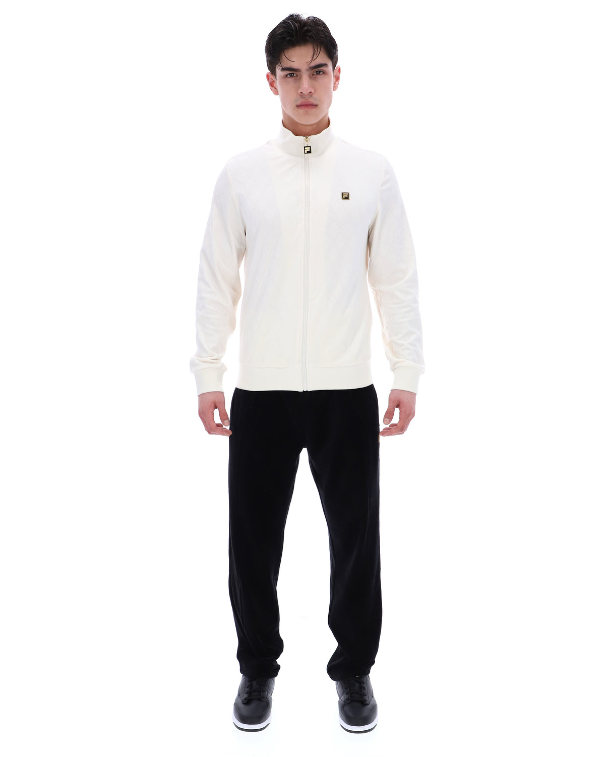 Man wearing a white jacket and black pants on a white background