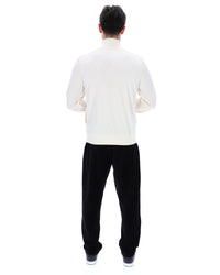 Person wearing a white shirt and black pants on a white background