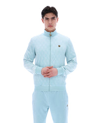 Man wearing a light blue tracksuit on a white background