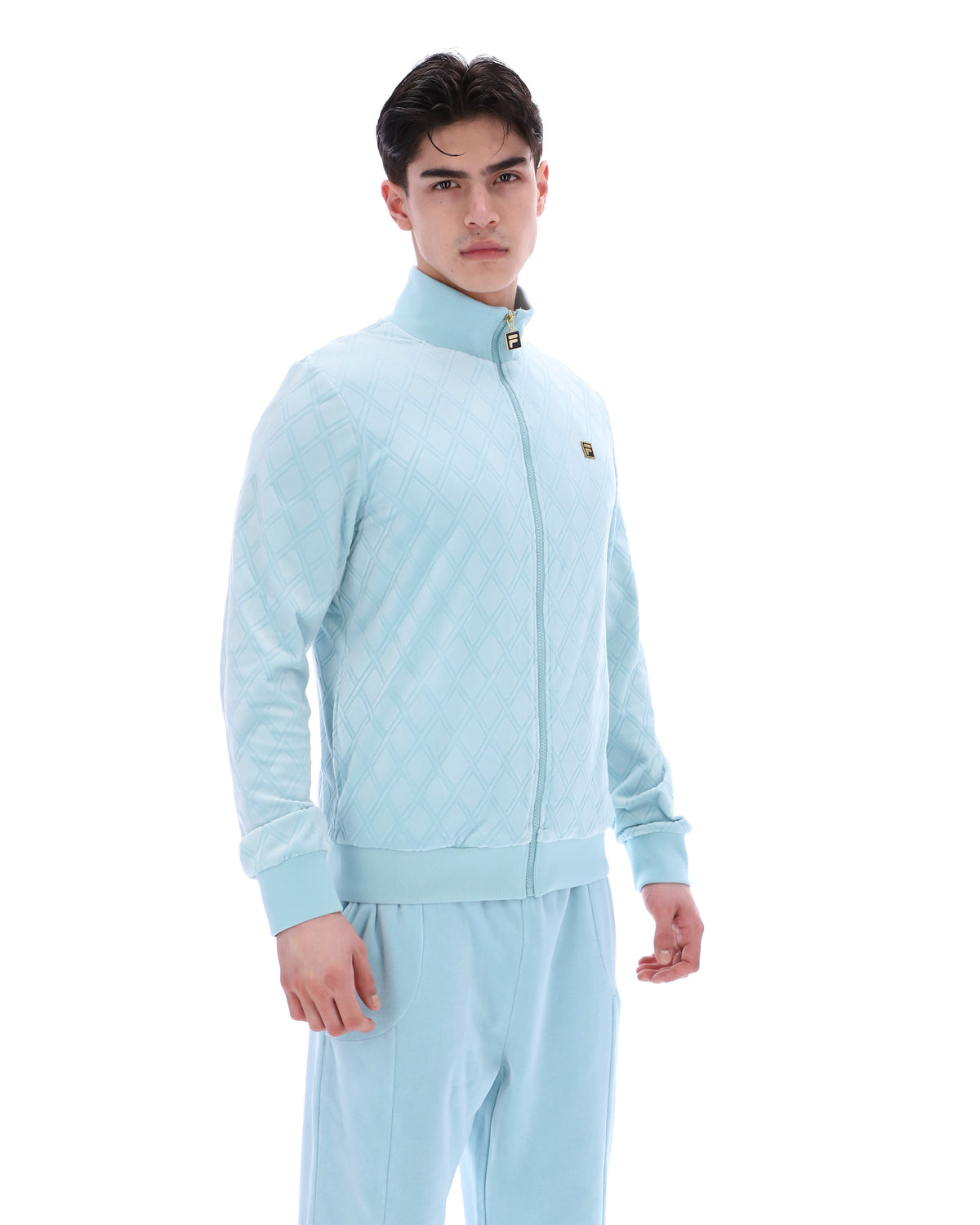 Man wearing a light blue tracksuit on a white background
