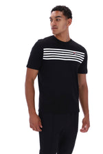 A man wearing a black short-sleeve crewneck t-shirt with a horizontal white stripe pattern across the chest and a small red and white logo on the right chest, paired with black pants, against a plain white background.